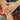 Close-up of hands with a ring against a floral background