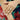 Close-up of a hand wearing a silver ring with a colorful floral background