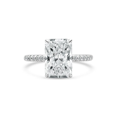 Diamond ring with a rectangular cut diamond on a white background