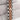 Rose gold and silver Rolex watch band on a textured fabric background