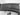 Close-up of a black office chair armrest with a blurred background