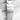 Close-up of a silver watch band with a brand logo on a textured white background
