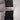 Black belt with a silver buckle on a light gray background