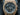 Gold watch with a dark gray face on a black background