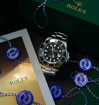 Rolex watch with decorative ribbons on a dark surface
