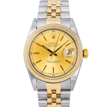 Two-tone gold and silver watch with a gold face on a white background