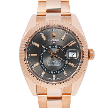 Rose gold watch with a detailed face on a white background