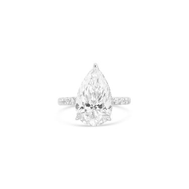 Pear-shaped diamond ring on a white background