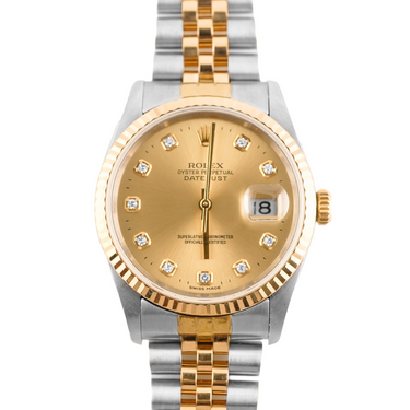 Two-tone gold and silver watch with a gold face on a white background