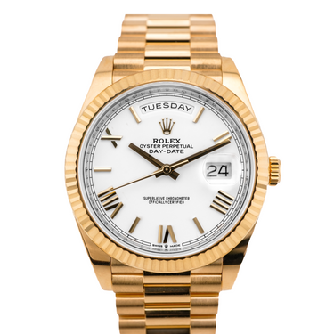 Gold Rolex watch with a white dial on a white background