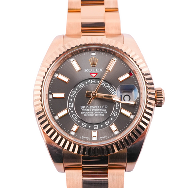 Rose gold Rolex watch with a gray dial on a white background