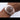 Rose gold Rolex watch with a brown dial on a white background