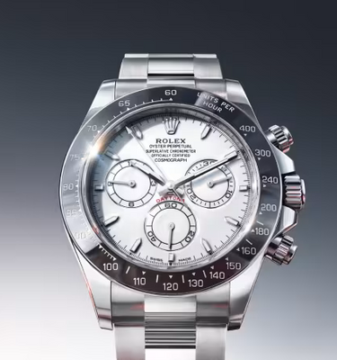 Silver watch on a reflective surface with dynamic light effects