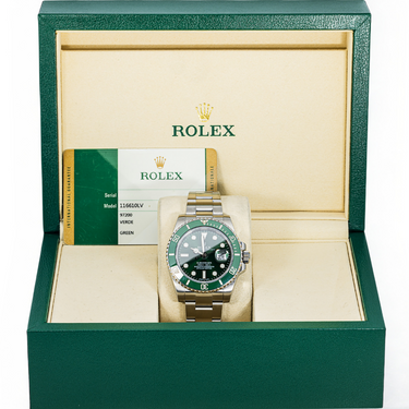 Rolex watch with green bezel and face in a green and beige box