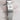 Close-up of a silver Rolex watch band with a brand logo on a textured surface