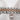 Close-up of a Rolex watch band with rose gold and silver links on a textured white background