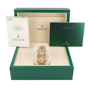 Rolex watch in a green box with warranty papers on a white background