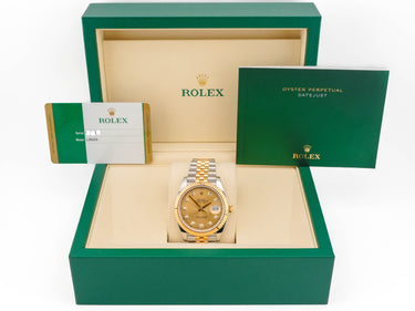 Rolex watch in a green box with a white background