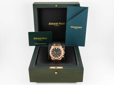 Audemars Piguet watch in a green box with a card on a white background