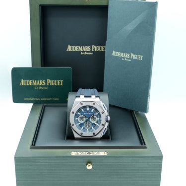 Luxury watch with blue strap and detailed face on a box