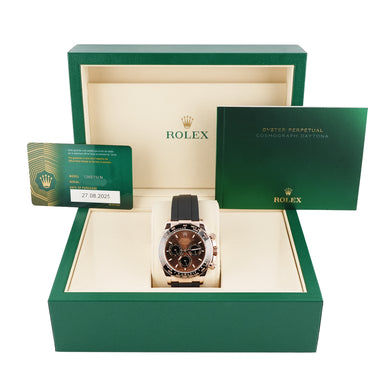 Rolex watch in a green box with a warranty card on a white background 