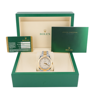 Rolex watch in a green box with warranty card on a white background
