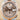 Rolex watch with rose gold and silver case on a beige background