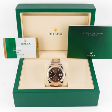 Rolex watch in a green box with a white background