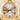 Gold Rolex watch with silver dial on a beige background