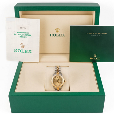 Rolex watch in a green box with branding visible