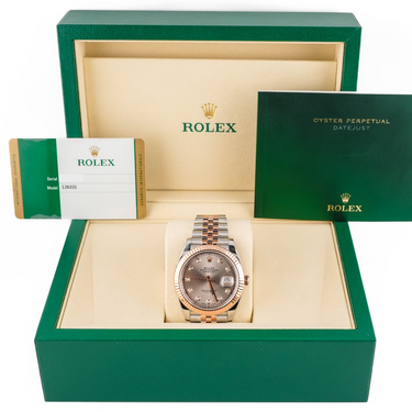 Rolex watch in a green box with the Rolex logo visible
