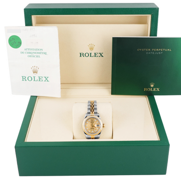 Rolex watch in a green box with accessories on a white background
