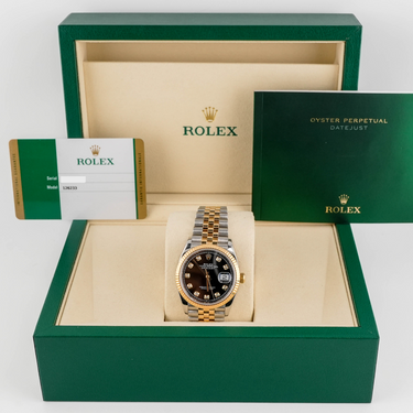Rolex watch in a green and beige box with the Rolex logo.