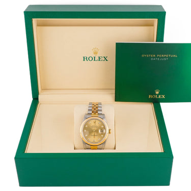 Rolex watch in a green box with a white background