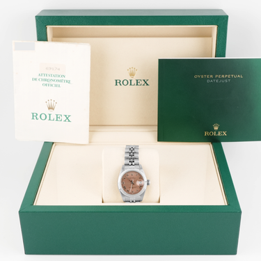 Rolex watch in a green box with the Rolex logo visible