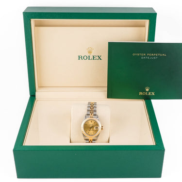 Gold watch in a green Rolex box on a white background