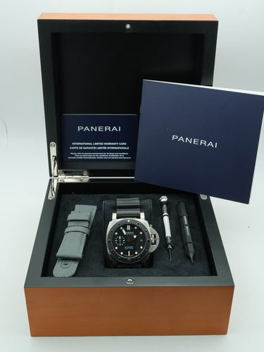 Panerai Submersible watch with black dial and rubber strap on a brown box