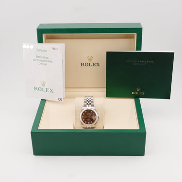 Rolex watch in a green box with a white background