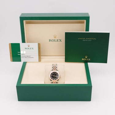 Rolex watch in a green box with a white background