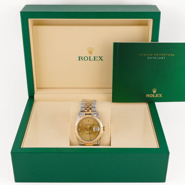 Gold watch in a green Rolex box on a white background