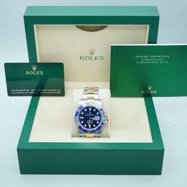 Rolex watch in a green box on a light blue background