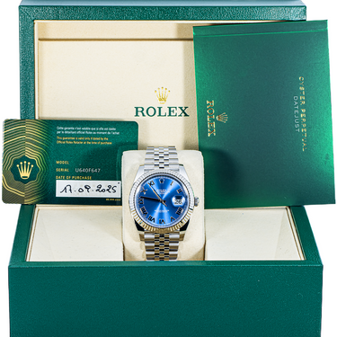 Rolex watch with blue face and silver bracelet in green box