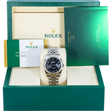 Rolex watch in a green box with the Rolex logo visible