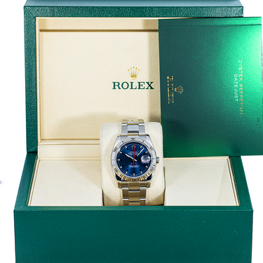 Rolex watch in a green box with a white interior