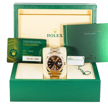 Rolex watch in a green box with accessories
