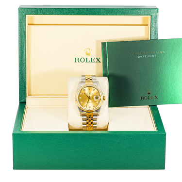 Gold Rolex watch in a green and gold box with the Rolex logo.