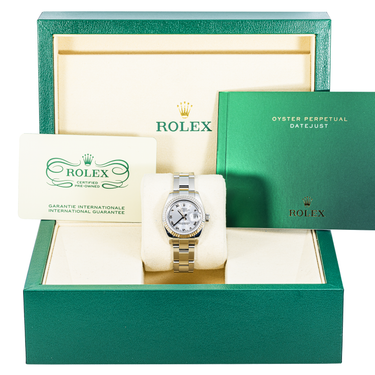 Rolex watch in a green box with branding and text