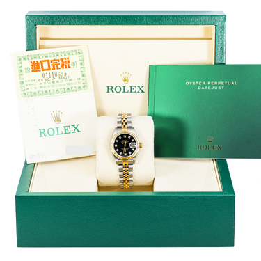 Rolex watch in green box with accessories