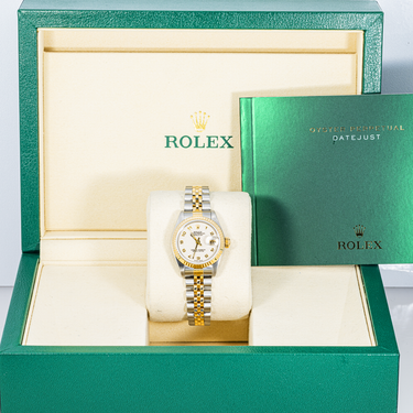 Rolex watch in a green Rolex box with a white interior