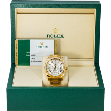 Gold watch in a green Rolex box with a white interior